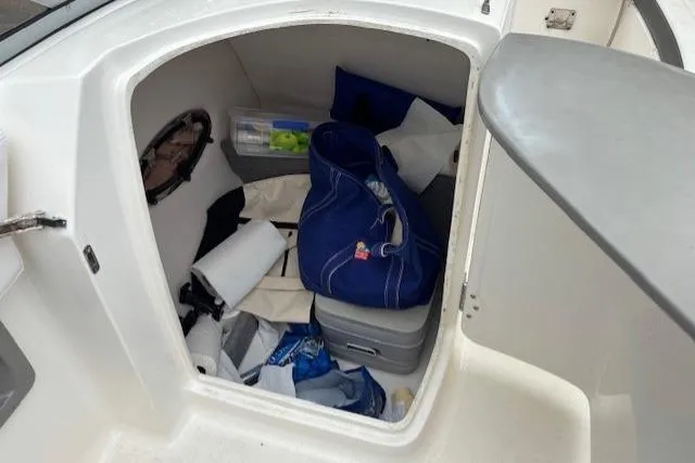 Slide: The Image of 2015 Chaparral 250 Suncoast boat with outboard motor, docked on concrete surface. - 10