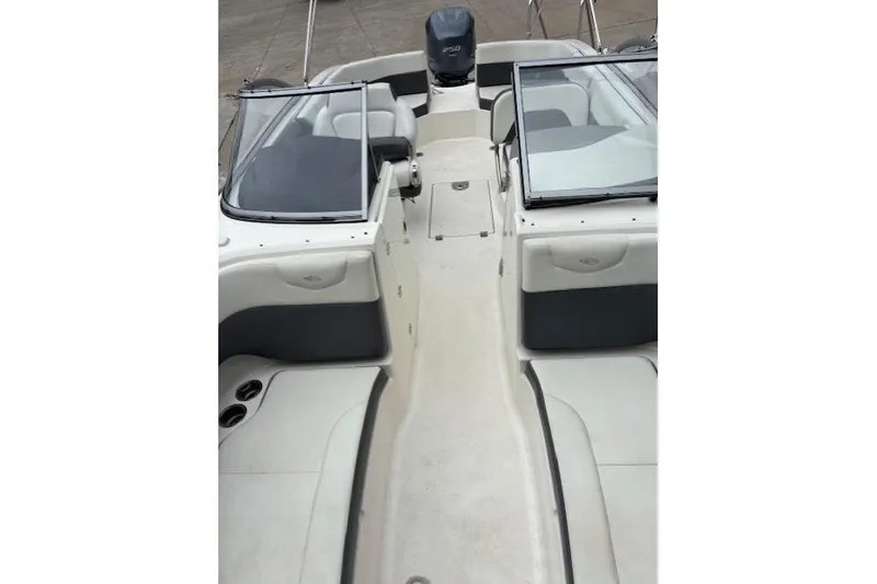 Slide: The Image of 2015 Chaparral 250 Suncoast boat docked at a marina with other boats. - 13