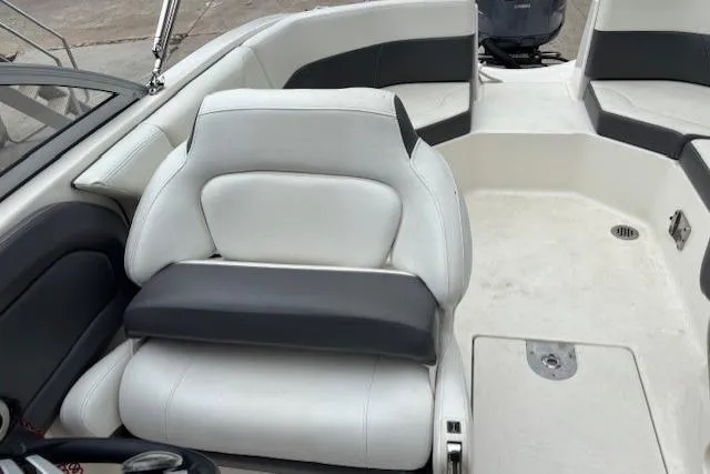 Slide: The Image of 2015 Chaparral 250 Suncoast boat with Yamaha 250 outboard motor, docked under blue sky. - 15