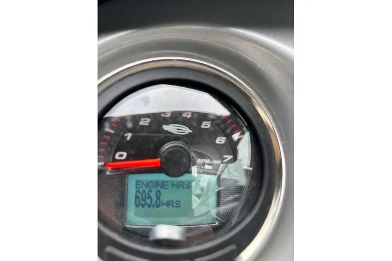 Slide: The Image of 2015 Chaparral 250 Suncoast boat with blue canopy in storage facility. - 18