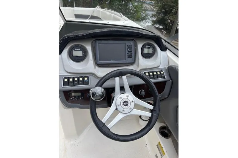 Slide: The Image of 2015 Chaparral 250 Suncoast boat interior with white and black seating. - 22