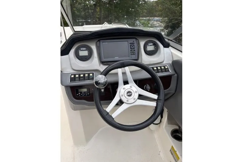 Slide: The Image of 2015 Chaparral 250 Suncoast boat interior with seating and steering console. - 23
