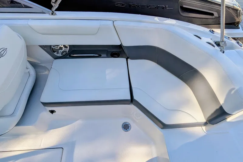 Slide: The Image of 2015 Chaparral 250 Suncoast boat interior with white and gray seating. - 28