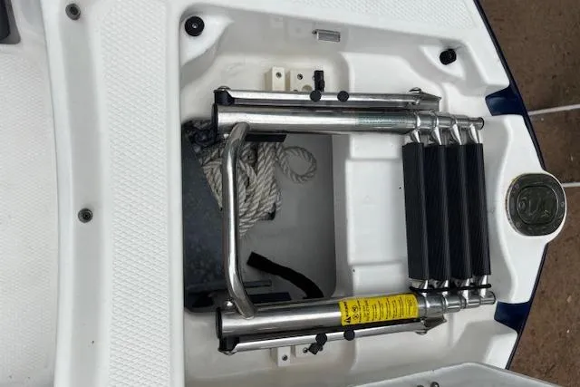 Slide: The Image of 2015 Chaparral 250 Suncoast boat ladder and storage compartment with rope. - 31