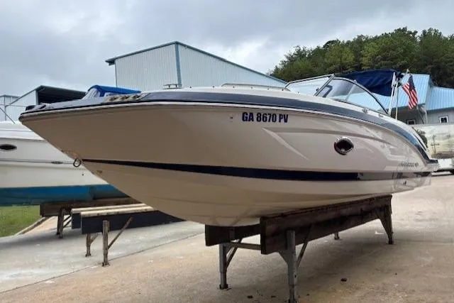 Slide: The Image of 2015 Chaparral 250 Suncoast boat on display, white hull with blue accents. - 4