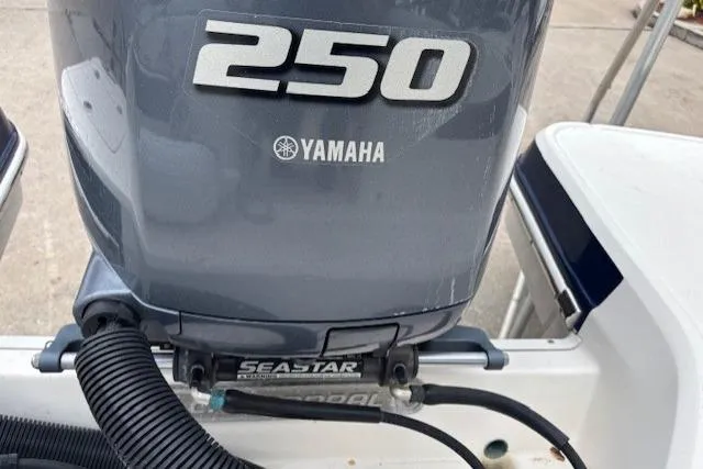 Slide: The Image of 2015 Chaparral 250 Suncoast boat on trailer, parked outdoors near buildings. - 6