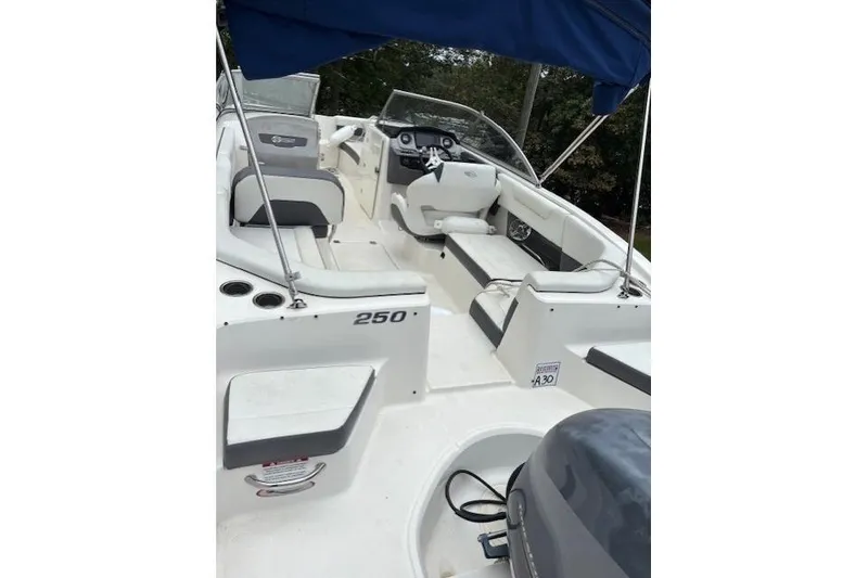 Slide: The Image of 2015 Chaparral 250 Suncoast boat with Yamaha engine, parked outdoors. - 8