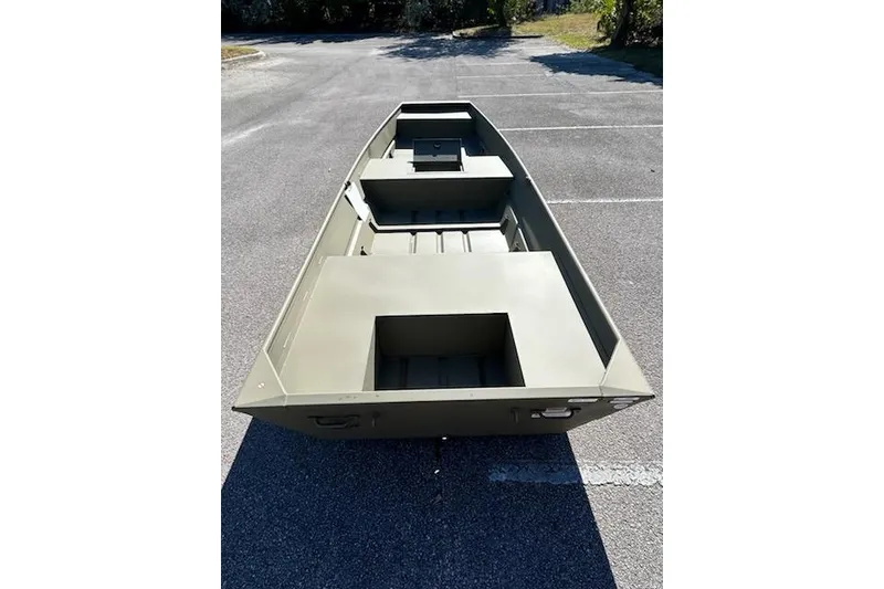 Slide: The Image of 2026 Tracker Grizzly 15 Jon boat in a parking lot, showcasing its spacious interior design. - 2