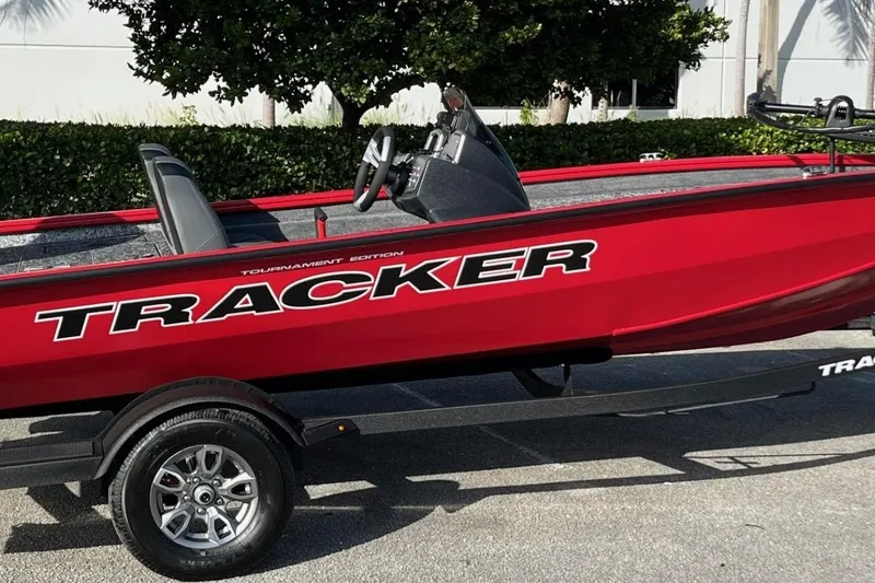 Slide: The Image of 2026 Tracker Pro Team 190 boat, red, on trailer, side view, outdoors. - 57