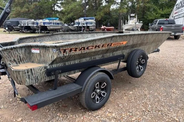 The Image of 2026 Tracker Grizzly 1756 T Marsh boat on trailer, camo design, parked outdoors. - 0