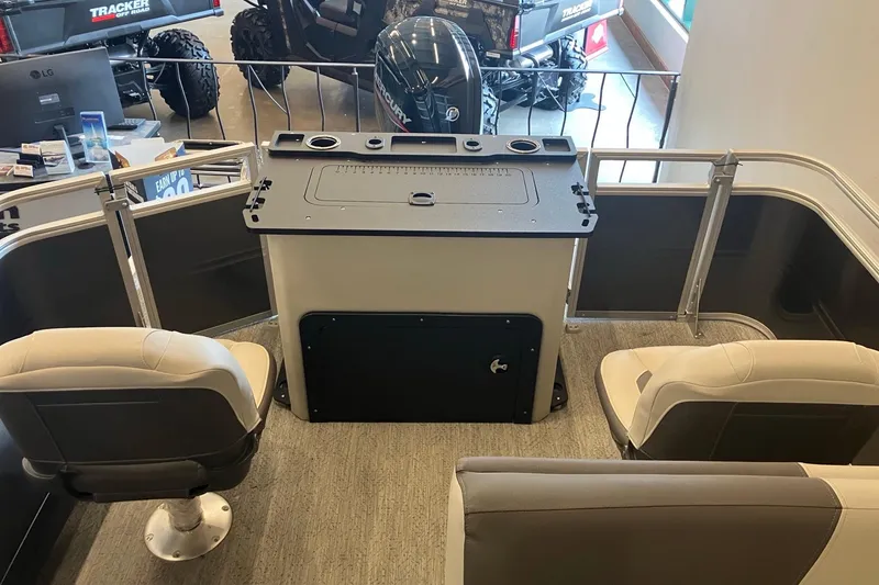 Slide: The Image of 2026 Sun Tracker Fishin' Barge 22 DLX interior with seating and control panel. - 4