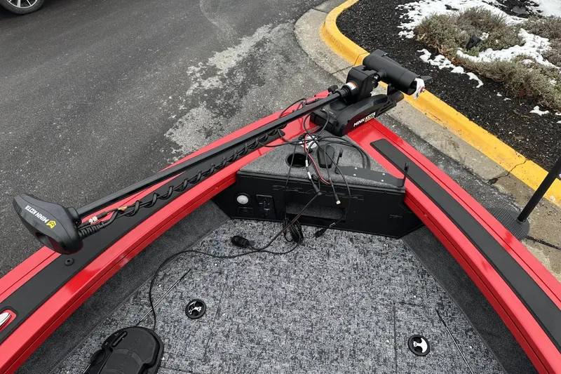 Slide: The Image of 2026 Tracker Targa V-19 Combo boat storage compartment with equipment and carpeted interior. - 13