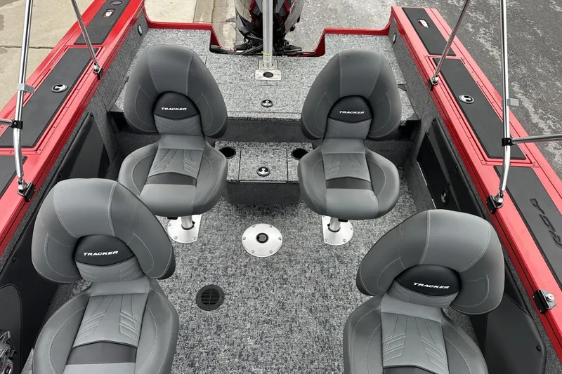 Slide: The Image of 2026 Tracker Targa V-19 Combo boat interior with four gray seats and red accents. - 14