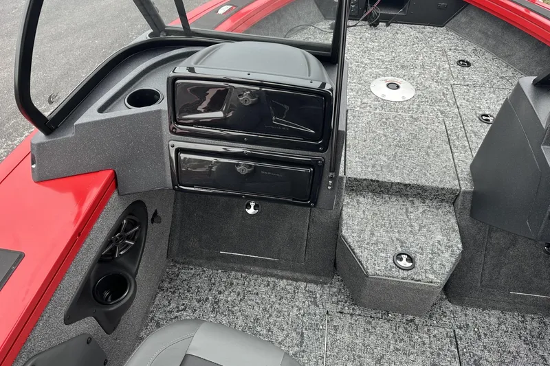 Slide: The Image of 2026 Tracker Targa V-19 Combo boat storage compartment with organized tackle boxes. - 18