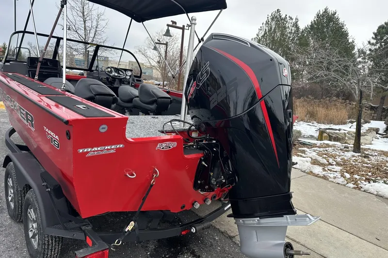 Slide: The Image of 2026 Tracker Targa V-19 Combo boat with powerful outboard motor in snowy setting. - 2