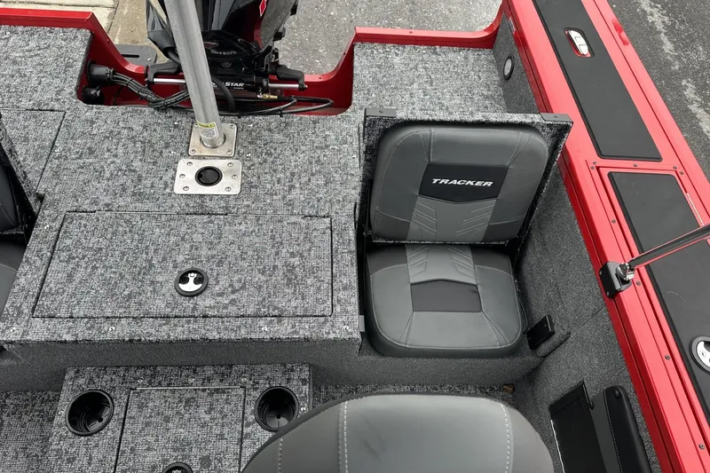 Slide: The Image of 2026 Tracker Targa V-19 Combo boat interior with rod storage and steering console. - 20