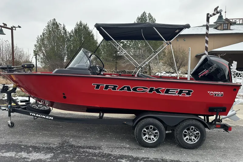 Slide: The Image of 2026 Tracker Targa V-19 Combo boat interior with green navigation light and water bottle. - 8