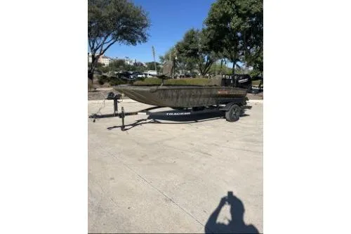 The Image of 2026 Tracker Grizzly 1756 T Marsh boat on trailer in sunny outdoor setting. - 0