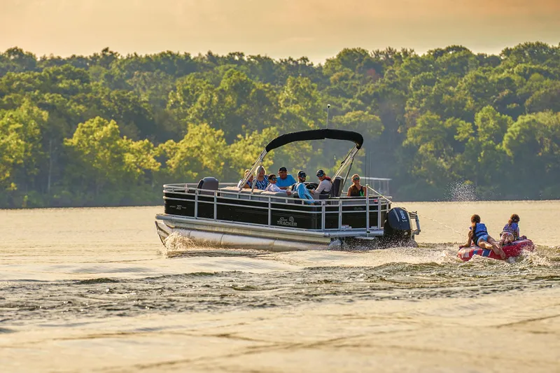 Slide: The Image of 2026 Sun Tracker Sportfish 24 XP3 boat helm with steering wheel and controls. - 2