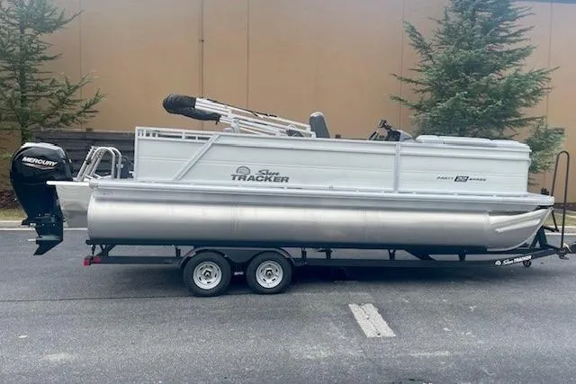 The Image of 2026 Sun Tracker Party Barge 22 RF XP3 pontoon boat on trailer, parked outdoors. - 0