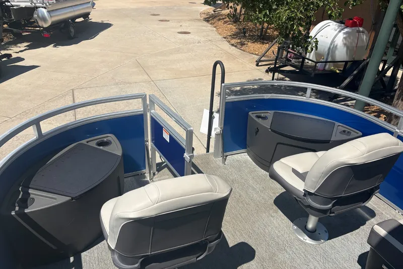 Slide: The Image of 2026 Sun Tracker Fishin' Barge 20 DLX interior with seating and storage compartments. - 17