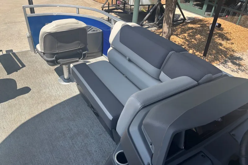 Slide: The Image of 2026 Sun Tracker Fishin' Barge 20 DLX interior with gray seating and steering chair. - 16