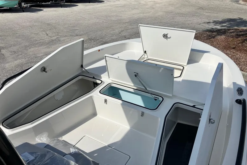 Slide: The Image of 2026 Ranger 2360 Bay boat with open storage compartments and sleek design. - 10