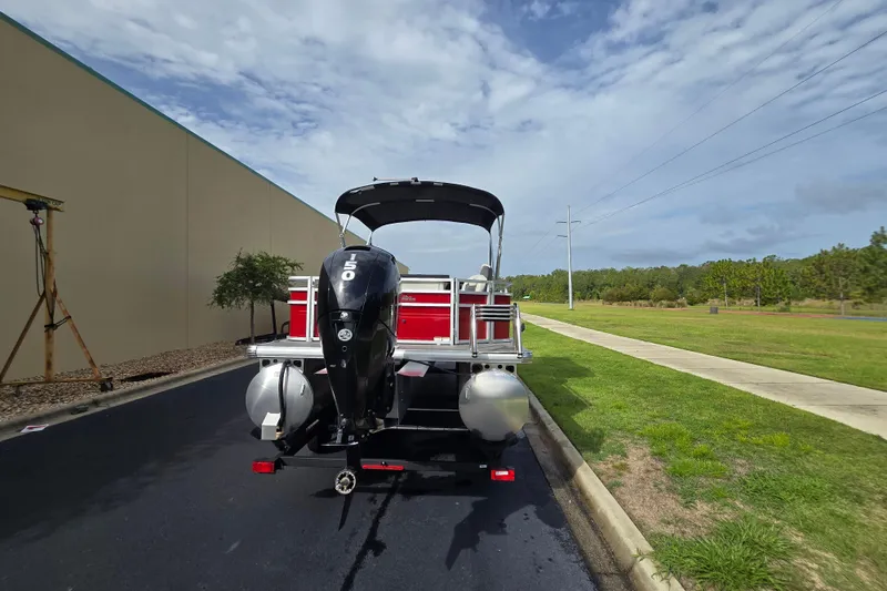 Slide: The Image of 2026 Sun Tracker Fishin' Barge 22 DLX pontoon boat with powerful outboard motor. - 66