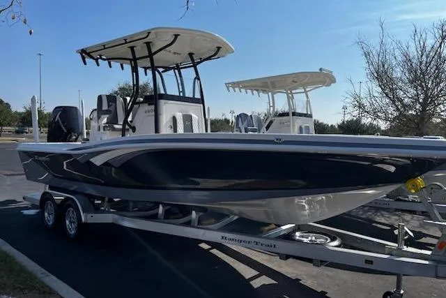 The Image of 2026 Ranger 2600 Bay boat on trailer, parked outdoors under clear sky. - 0