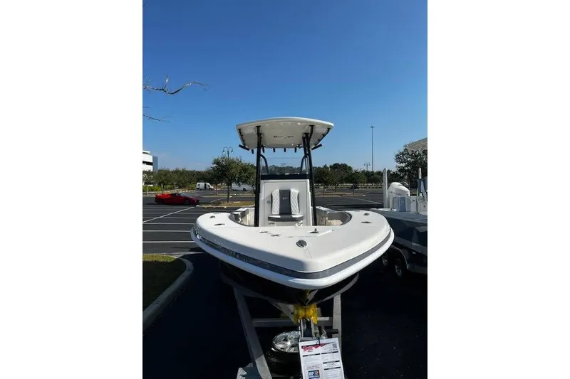 Slide: The Image of 2026 Ranger 2600 Bay boat displayed outdoors under clear blue sky. - 2