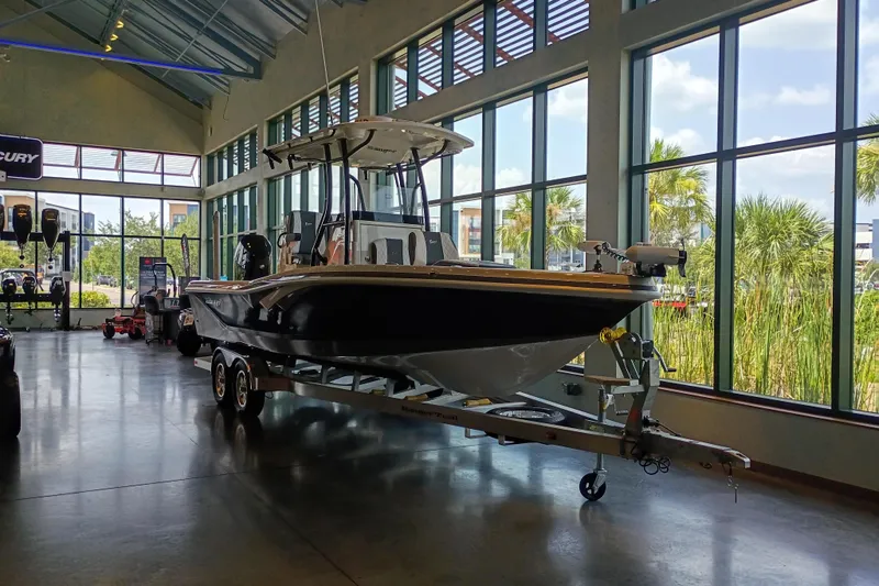Slide: The Image of 2026 Ranger 2600 Bay boat displayed indoors with large windows and natural lighting. - 1