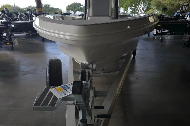Slide: The Image of 2026 Mako 24 APEX boat on trailer in showroom, front view. - 1
