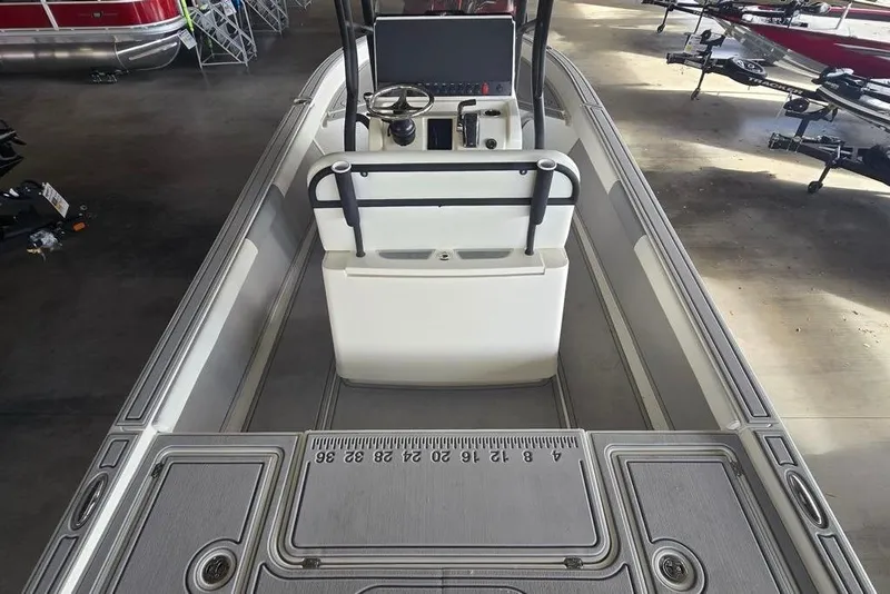 Slide: The Image of 2026 Mako 24 APEX boat interior with steering console and measurement markings. - 3