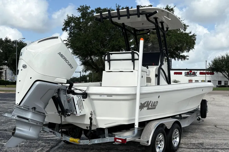 Slide: The Image of 2026 Mako 24 APEX boat on trailer, featuring a powerful Mercury outboard motor. - 4