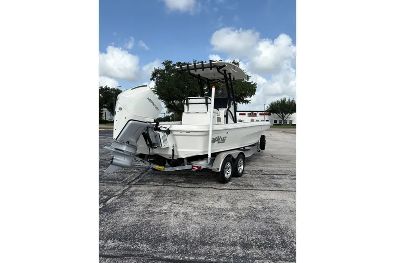 Slide: The Image of 2026 Mako 24 APEX boat on trailer, featuring a powerful Mercury outboard motor. - 5