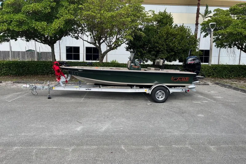 Slide: The Image of 2026 Mako 18 Pro Skiff Backwater Edition on trailer in parking lot. - 0