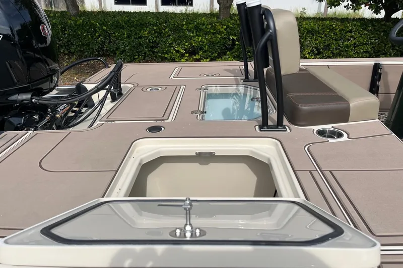 Slide: The Image of 2026 Mako 18 Pro Skiff Backwater Edition boat interior with storage compartments and seating. - 12
