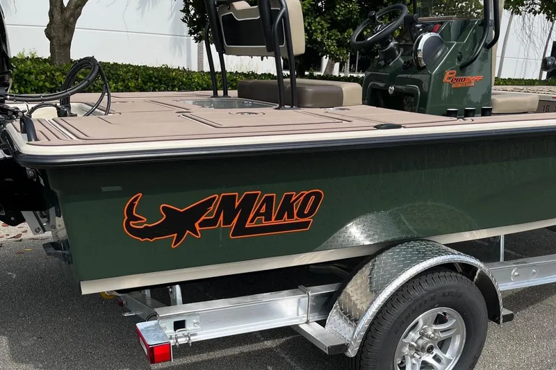 Slide: The Image of 2026 Mako 18 Pro Skiff Backwater Edition boat on trailer, side view. - 13