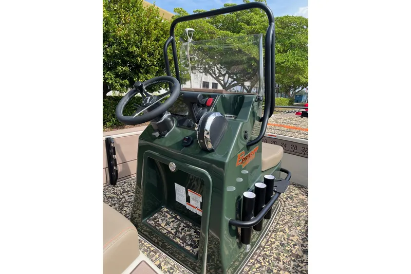 Slide: The Image of 2026 Mako 18 Pro Skiff Backwater Edition console with steering wheel and rod holders. - 4