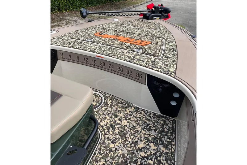 Slide: The Image of 2026 Mako 18 Pro Skiff Backwater Edition with camo deck and Minn Kota trolling motor. - 7
