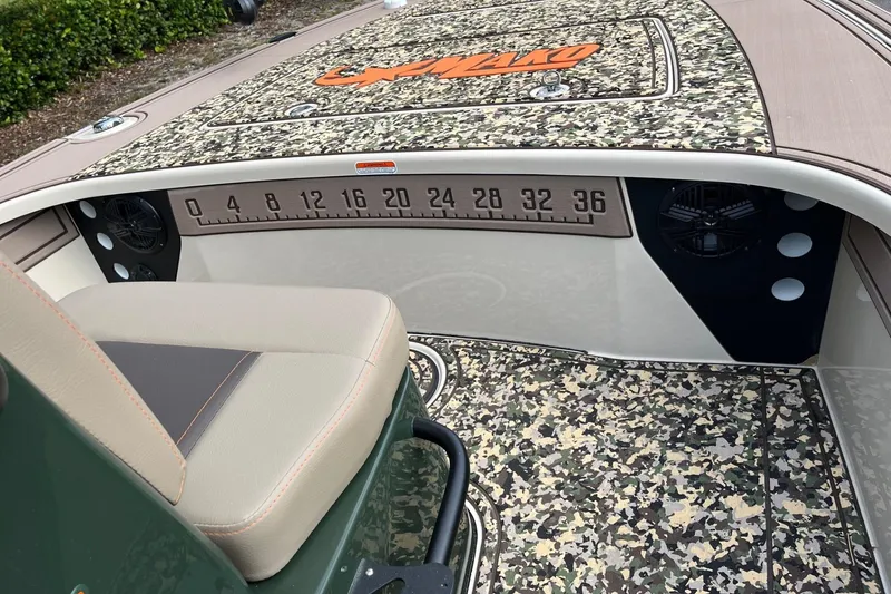 Slide: The Image of 2026 Mako 18 Pro Skiff Backwater Edition interior with camo design and measurement scale. - 8
