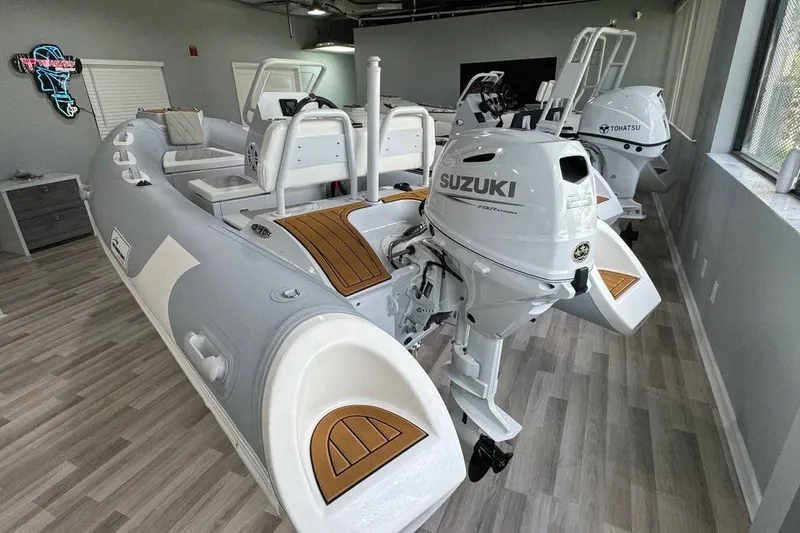 Slide: The Image of 2026 East Marine 360 boat with Suzuki outboard motor in showroom. - 10