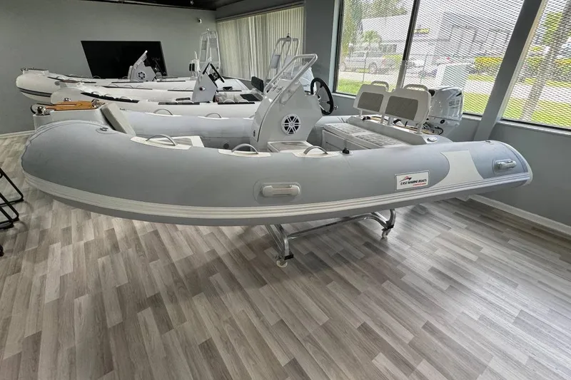 Slide: The Image of Inflatable boat East Marine 360, 2026 model, displayed in showroom with wooden flooring. - 15