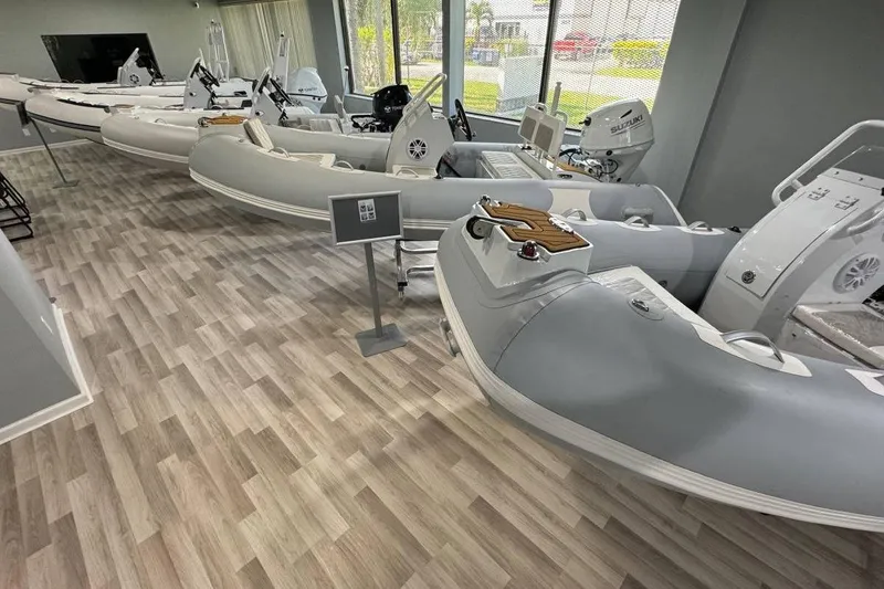 Slide: The Image of Showroom displaying 2026 East Marine 360 inflatable boats on wooden flooring. - 18