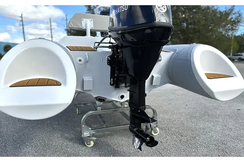 Slide: The Image of Manufacturer Provided Image: 2025 East Marine 360 boat with outboard motor on display outdoors. - 6