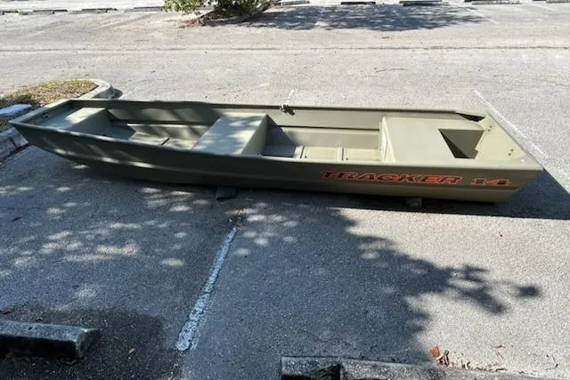 Slide: The Image of 2026 Tracker Grizzly 14 Jon boat parked on pavement, showcasing its sturdy design. - 59
