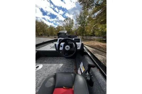 Slide: The Image of 2026 Tracker Pro Team 175 Crappie Edition boat interior with steering wheel and seating. - 6