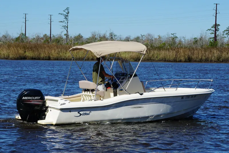 Slide: The Image of 2015 Scout 215 XSF boat with Mercury engine cruising on a calm river. - 16