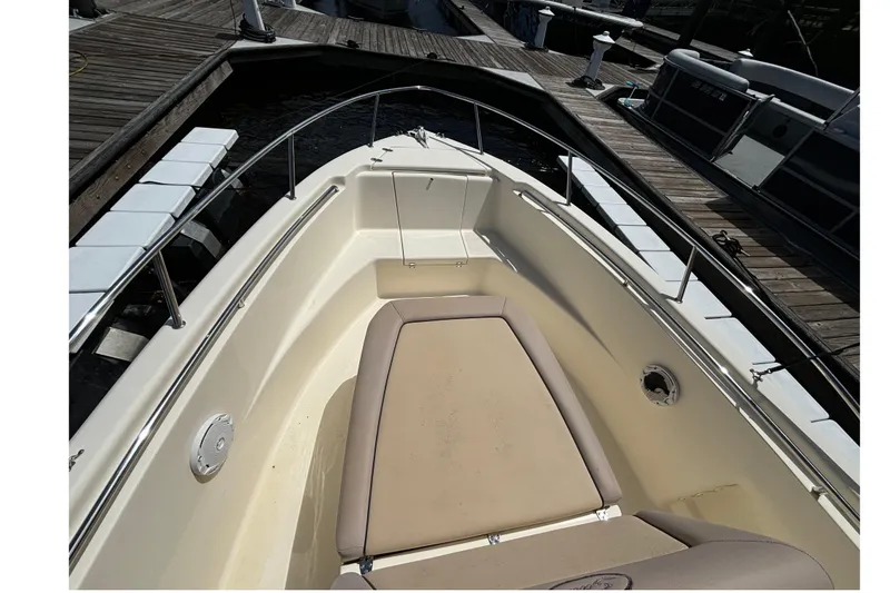 Slide: The Image of 2015 Scout 215 XSF boat interior with cushioned seating at dock. - 3