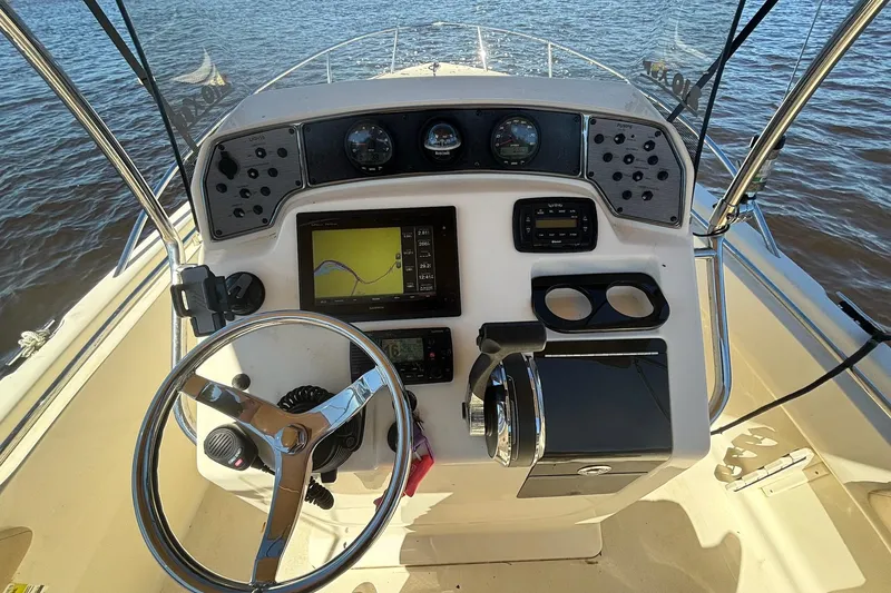 Slide: The Image of Control panel of 2015 Scout 215 XSF boat with steering wheel and navigation system. - 8